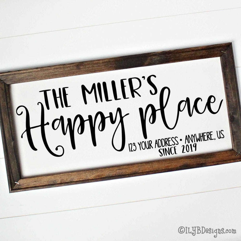 Personalized sign with 'The Miller's Happy Place' and custom address and established date in black text on a white canvas with brown wood frame.