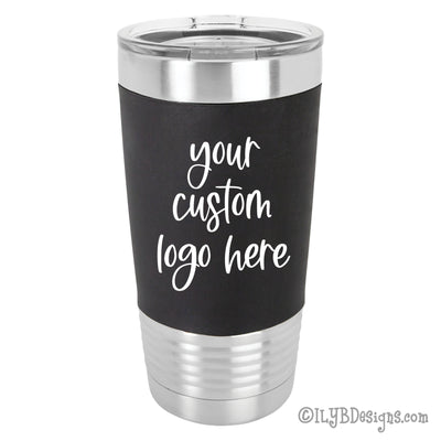 20 oz stainless steel tumbler with clear lid and black silicone sleeve with "your custom logo here" engraved in white on the silicone sleeve