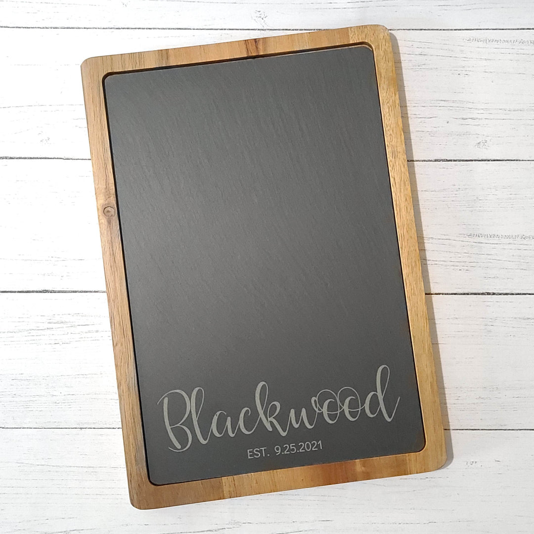 wood and slate charcuterie board on a white wooden surface
