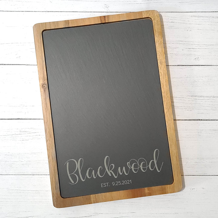 wood and slate charcuterie board on a white wooden surface