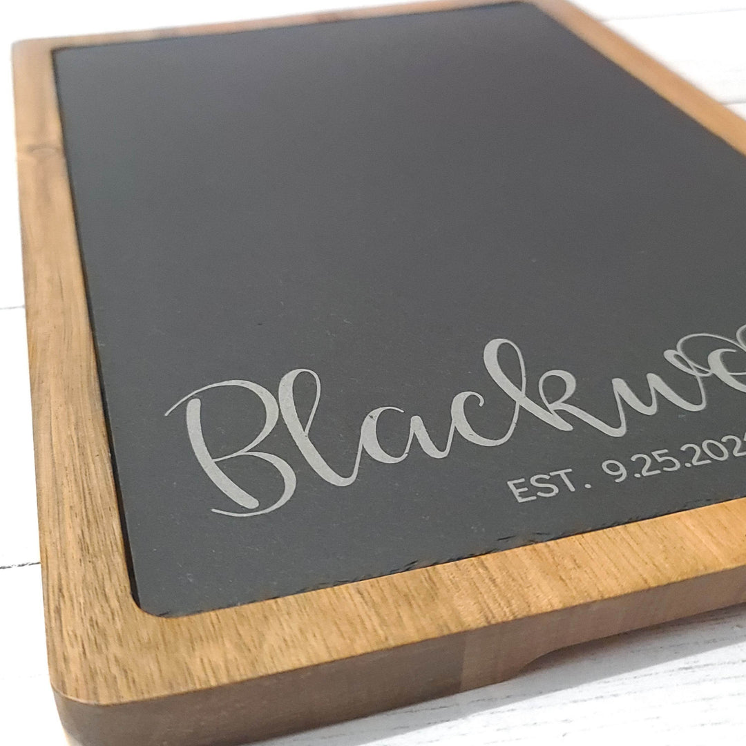 close up of wood and slate charcuterie board engraving