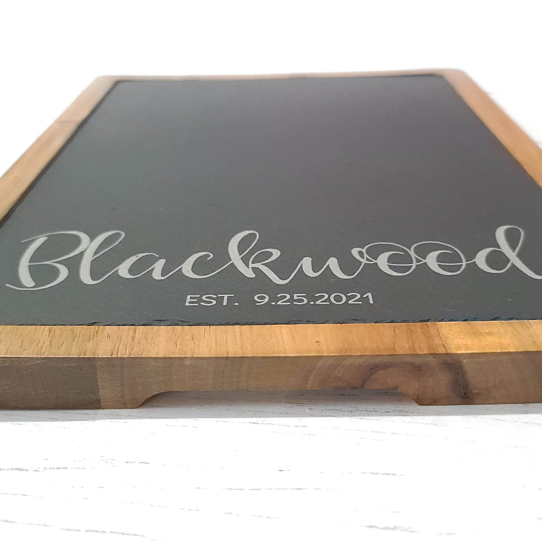 close up of engraving on slate and wood charcuterie board